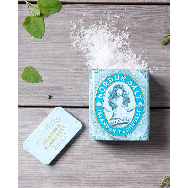 blue tin can with slat and mermaid on top of the salt