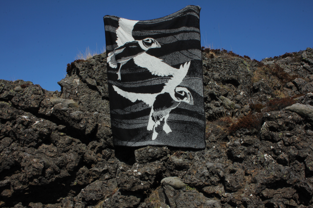 Textile with a black and white design on a rocky surface