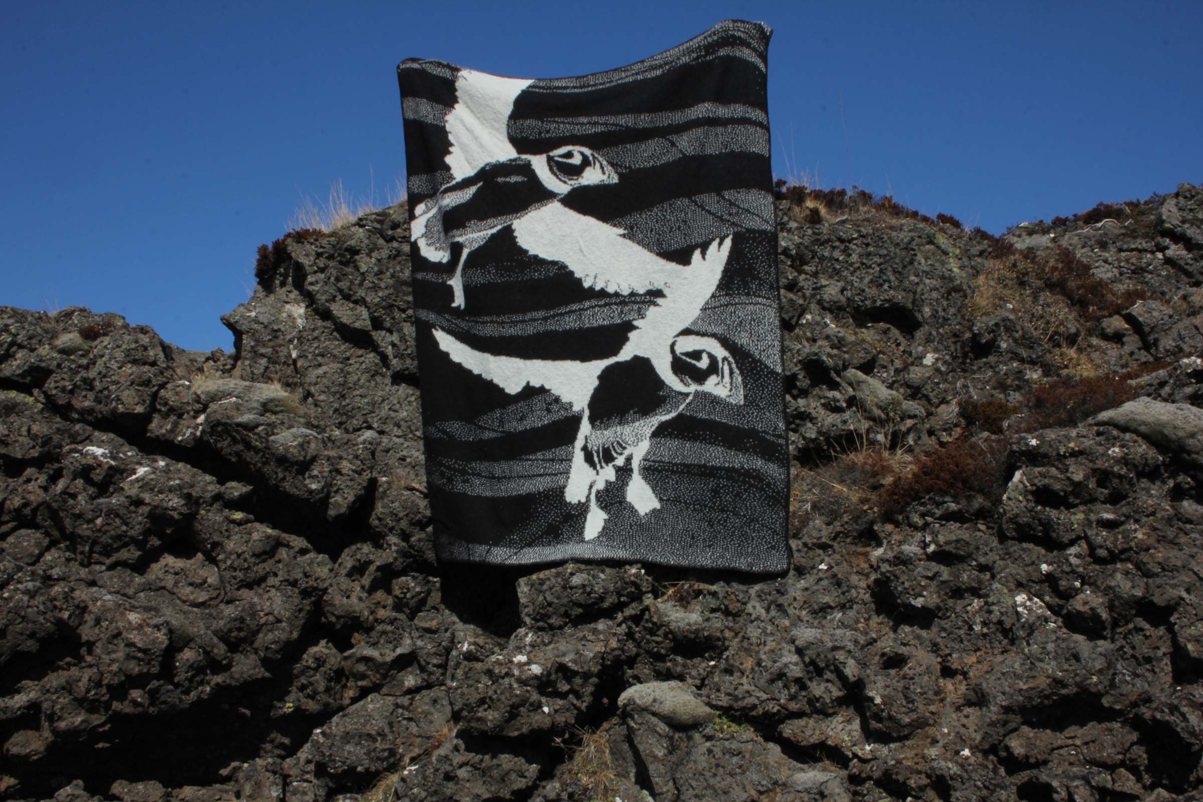 Textile with a black and white design on a rocky surface