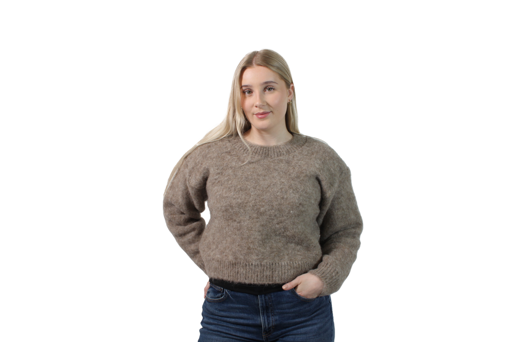Woman wearing a brown sweater on a white background